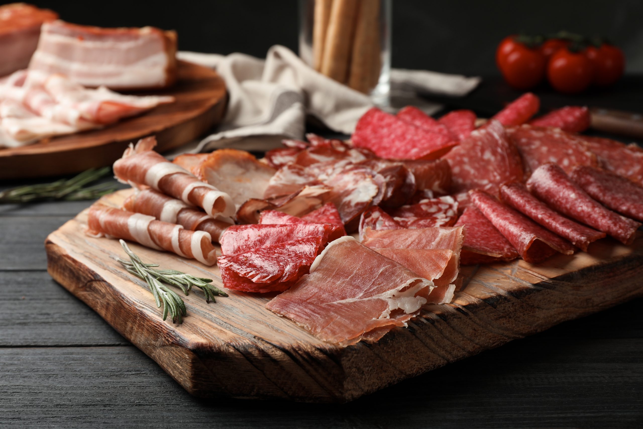 Cutting board with different sliced meat products served on table Paella and Tapas